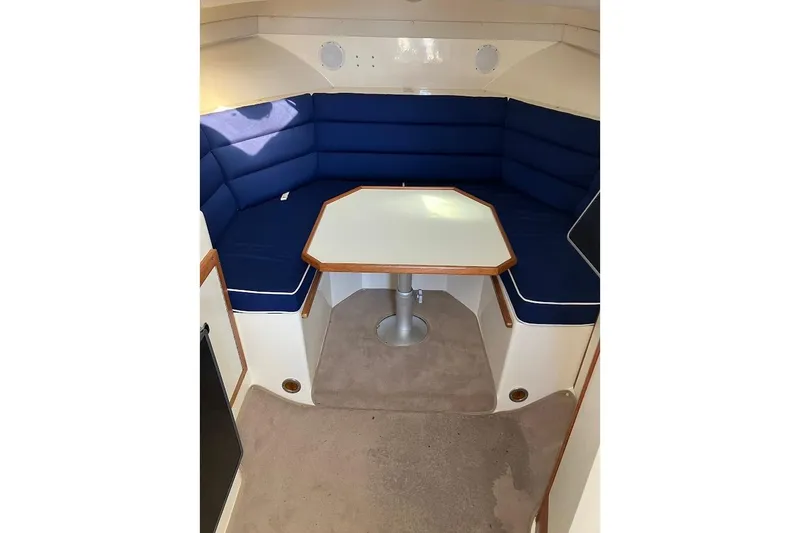 Slide: The Image of 2000 Albin 28 Tournament cabin interior with blue seating and table. - 3