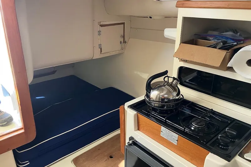 Slide: The Image of Interior of 2000 Albin 28 Tournament boat with kitchenette and sleeping area. - 4