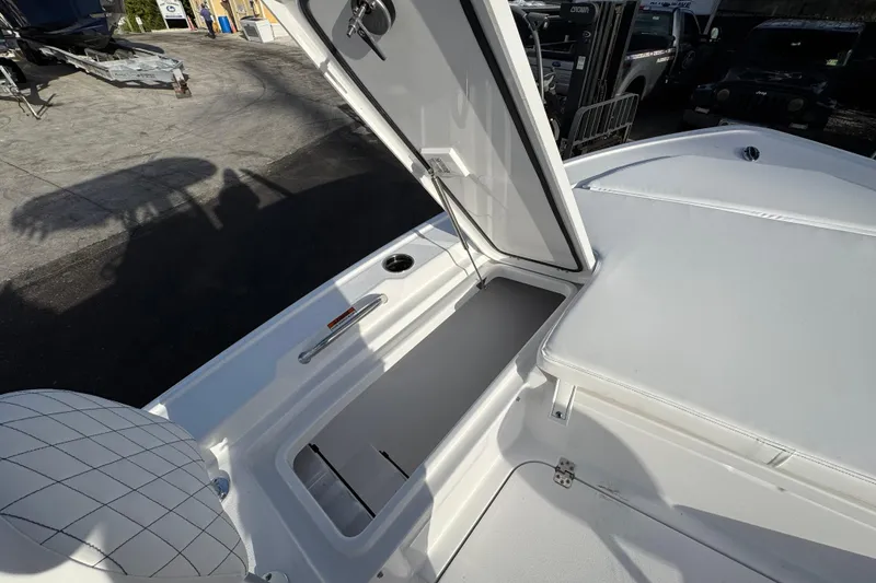 Slide: The Image of 2026 Sportsman Masters 227 Bay Boat with open storage compartment on deck. - 16