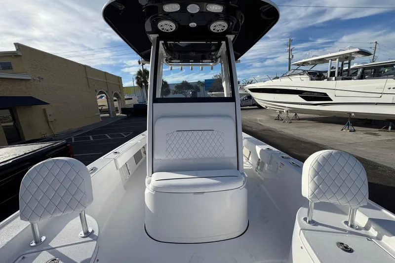 Slide: The Image of 2026 Sportsman Masters 227 Bay Boat interior with white seating and modern design. - 17