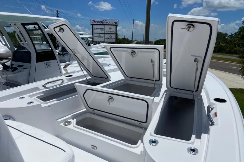 Slide: The Image of 2026 Sportsman Masters 227 Bay Boat with open storage compartments, displayed at Thunder Marine. - 23