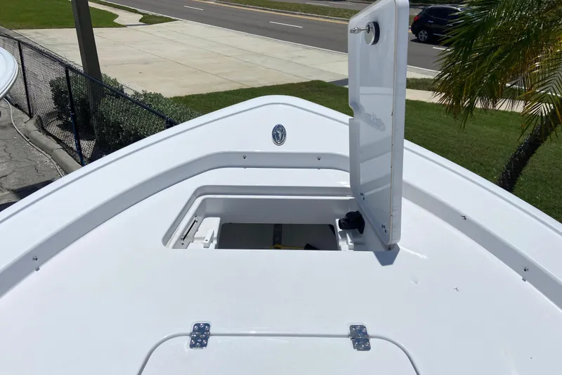 Slide: The Image of Bow storage compartment on 2026 Sportsman Masters 227 Bay Boat, open lid, sunny day. - 26
