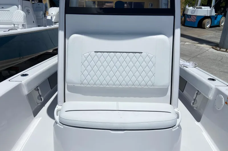 Slide: The Image of 2026 Sportsman Masters 227 Bay Boat interior with white cushioned seating. - 28