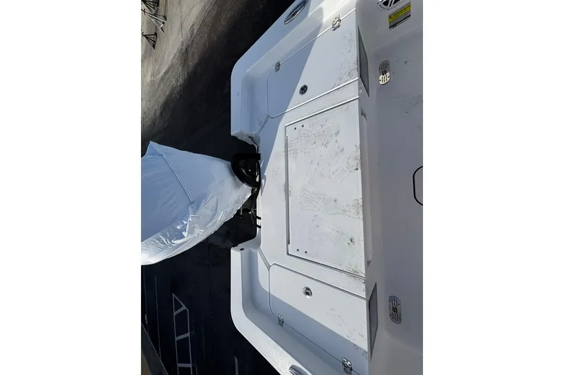 Slide: The Image of 2026 Sportsman Masters 227 Bay Boat, rear deck view, showcasing storage compartments. - 8