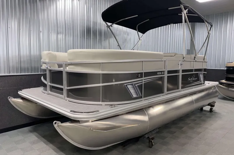 Slide: The Image of 2026 SunChaser Vista 18 LR pontoon boat in showroom, featuring sleek design and comfortable seating. - 13