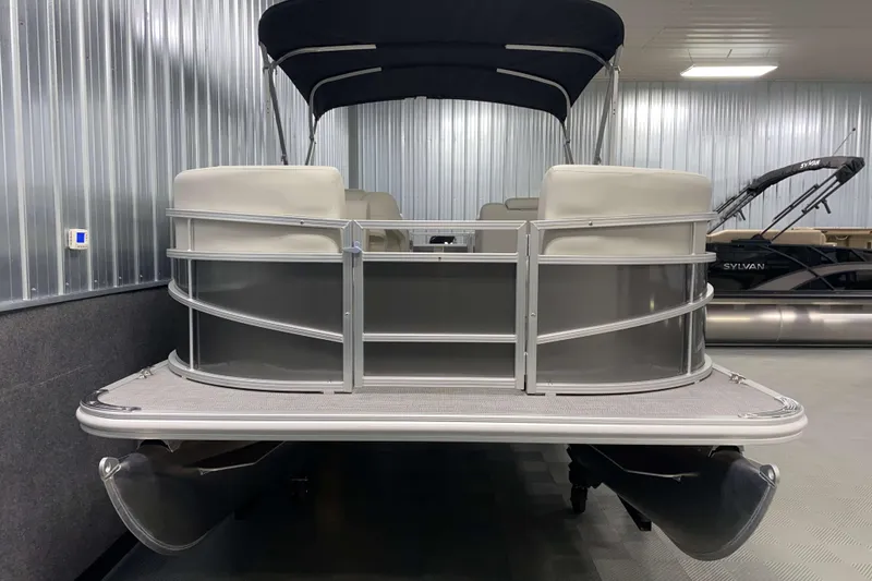 Slide: The Image of 2026 SunChaser Vista 18 LR pontoon boat in showroom, featuring sleek design and modern amenities. - 14