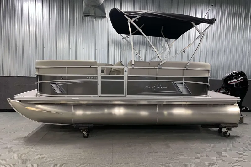 Slide: The Image of 2026 SunChaser Vista 18 LR pontoon boat with canopy in a showroom. - 15