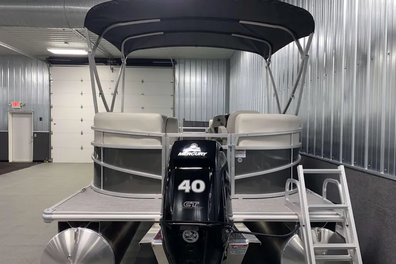 Slide: The Image of 2026 SunChaser Vista 18 LR pontoon boat in a metal-walled storage facility. - 17