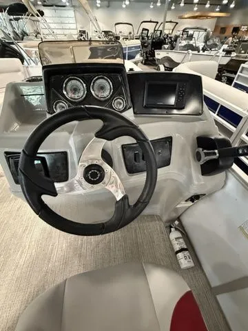 Slide: The Image of 2023 SunCatcher Select 20RC boat dashboard with steering wheel and control panel. - 9