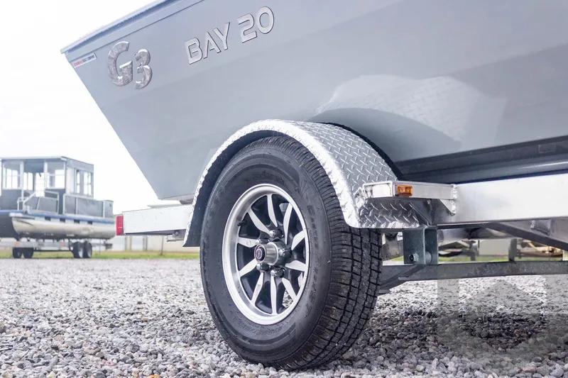 Slide: The Image of 2026 G3 Bay 20 boat on trailer, close-up of wheel and fender. - 21