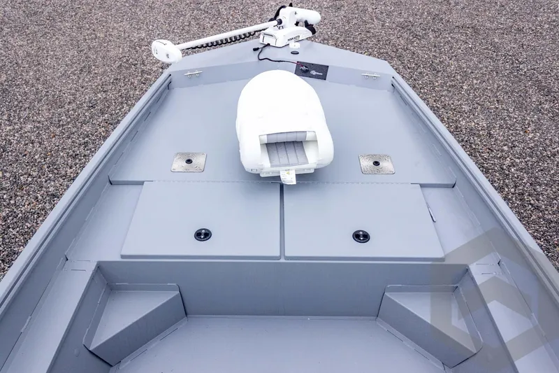 Slide: The Image of 2026 G3 Bay 20 boat deck with trolling motor and storage compartments. - 22