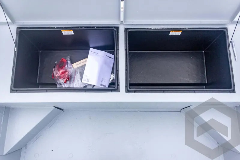 Slide: The Image of Open storage compartments in a 2026 G3 Bay 20 boat, containing documents and accessories. - 24