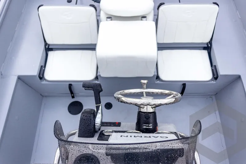 Slide: The Image of 2026 G3 Bay 20 boat interior with white seating and steering console. - 30