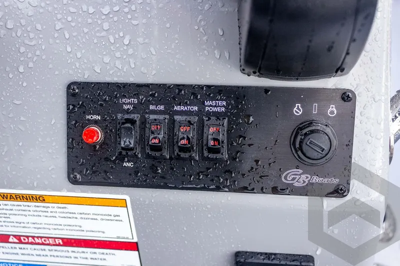 Slide: The Image of Control panel of G3 Bay 20 boat, 2026 model, with switches and warning labels. - 35