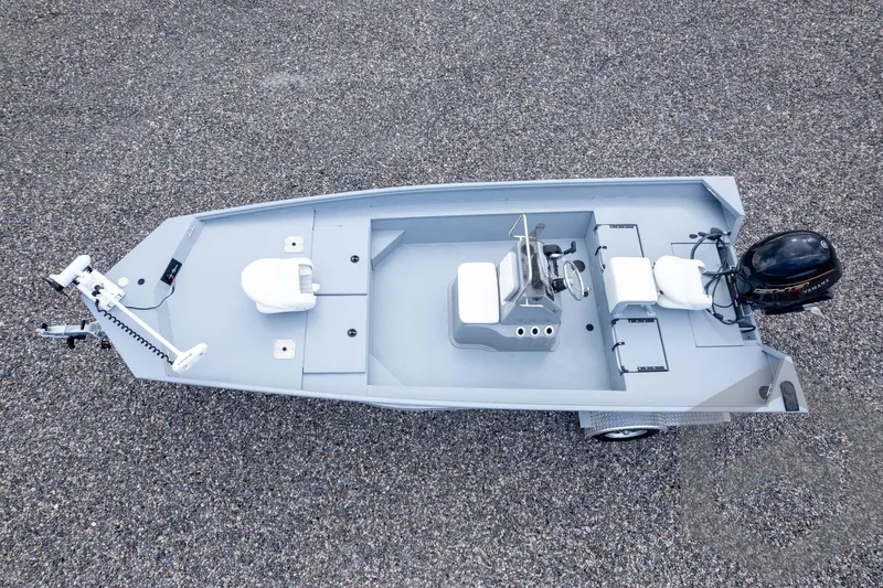 Slide: The Image of Overhead view of 2026 G3 Bay 20 boat on gravel surface, featuring seating and motor. - 43