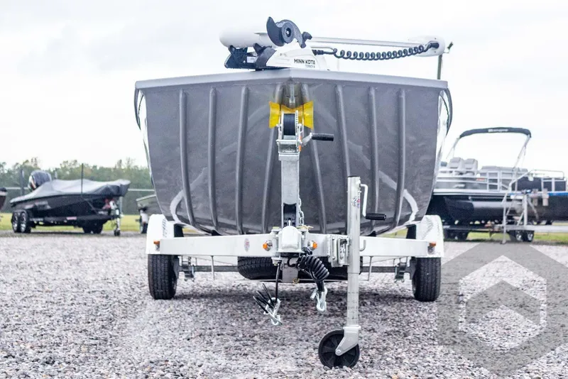 Slide: The Image of 2026 G3 Bay 20 boat on trailer, front view, parked on gravel lot. - 6