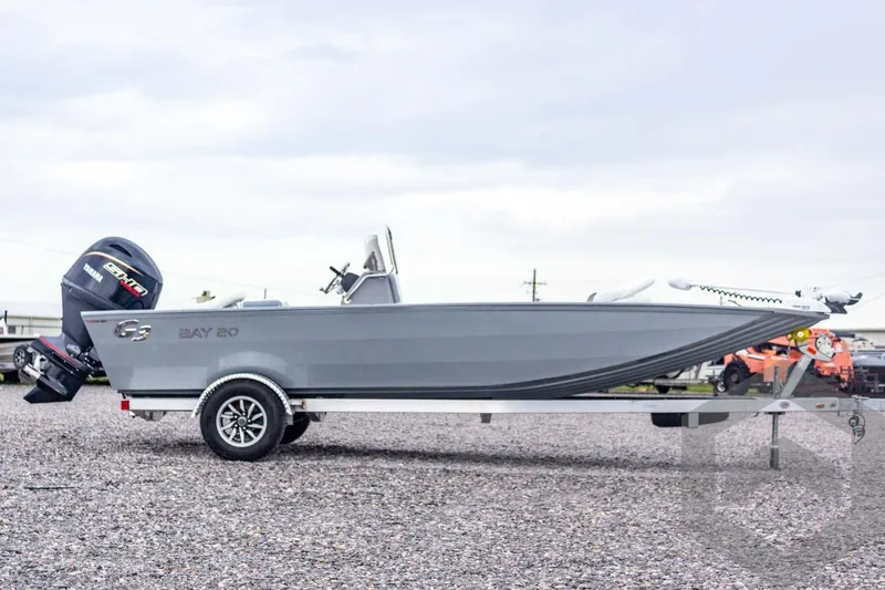 Slide: The Image of 2026 G3 Bay 20 boat on trailer with Yamaha outboard motor, parked on gravel. - 8
