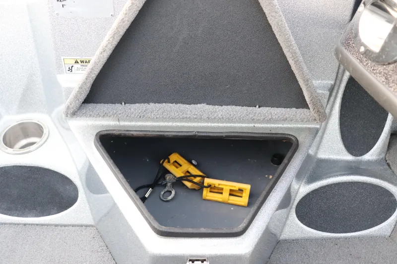 Slide: The Image of 2019 Bass Cat Lynx boat storage compartment with safety equipment inside. - 10