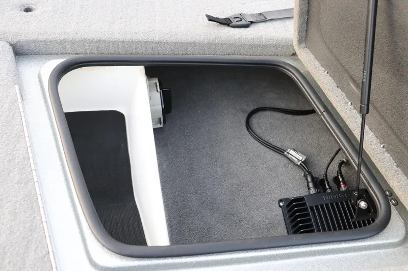 Slide: The Image of 2019 Bass Cat Lynx storage compartment with electronic equipment and wiring. - 6