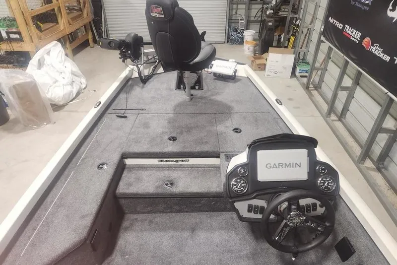 Slide: The Image of 2026 Ranger RT178 boat interior with Garmin navigation system and steering wheel in a garage setting. - 11