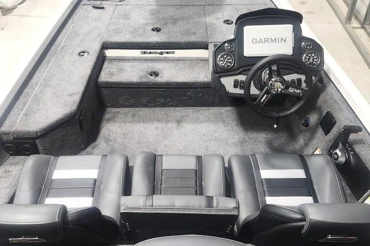 Slide: The Image of 2026 Ranger RT178 boat interior with Garmin navigation, featuring sleek black seating and modern dashboard. - 12