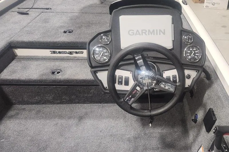 Slide: The Image of 2026 Ranger RT178 boat dashboard with Garmin display and steering wheel. - 7