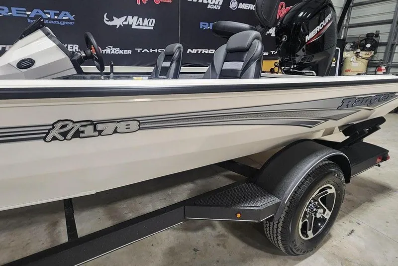 Slide: The Image of 2026 Ranger RT178 boat with Mercury engine, displayed in a showroom. - 8