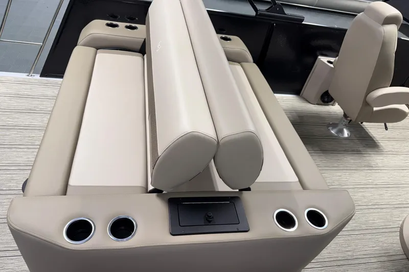 Slide: The Image of 2026 Premier 230 Sunsation RL Tritoon interior with beige seating and cup holders. - 10