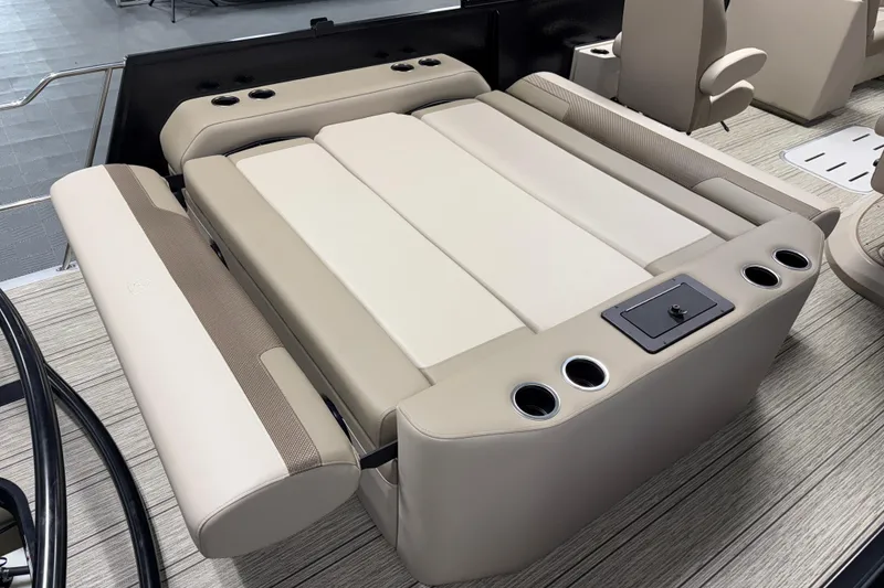 Slide: The Image of 2026 Premier 230 Sunsation RL Tritoon interior seating with cup holders and modern design. - 12