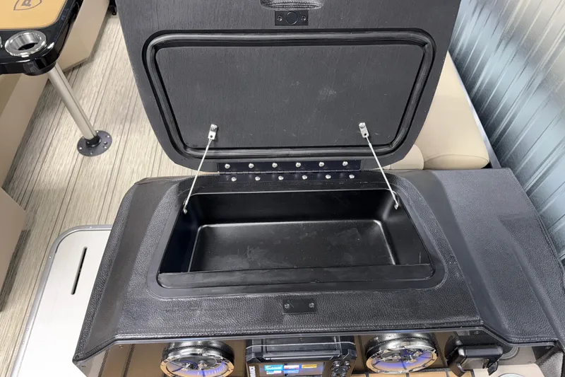 Slide: The Image of Open storage compartment on 2026 Premier 230 Sunsation RL Tritoon boat. - 17