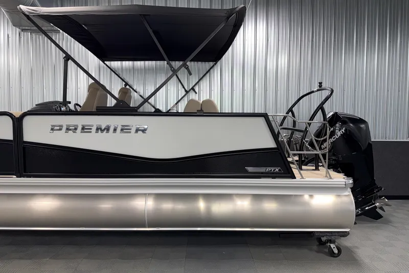 Slide: The Image of 2026 Premier 230 Sunsation RL Tritoon with canopy in a showroom. - 5