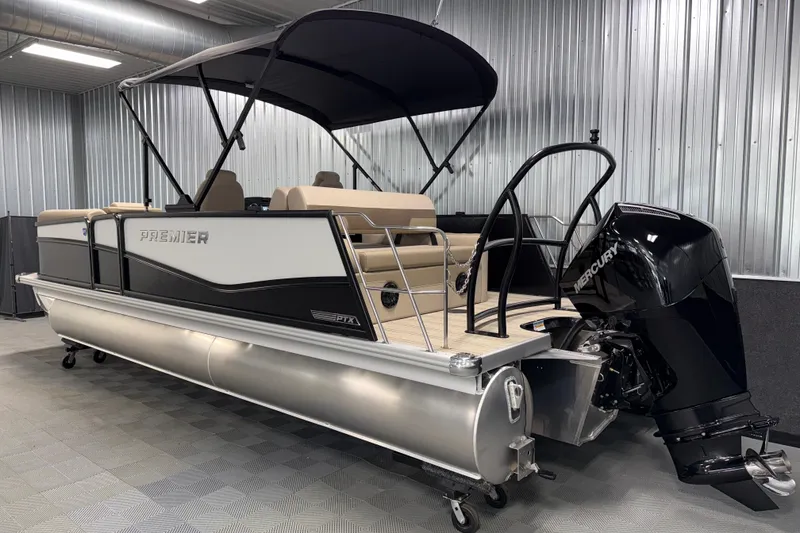 Slide: The Image of 2026 Premier 230 Sunsation RL Tritoon boat with Mercury outboard in a showroom. - 6