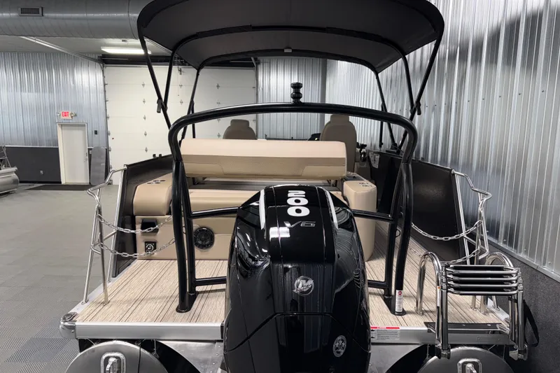 Slide: The Image of 2026 Premier 230 Sunsation RL Tritoon with powerful 200 HP engine in a showroom. - 7