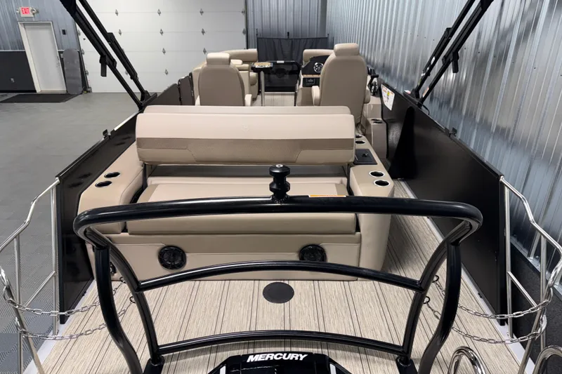 Slide: The Image of 2026 Premier 230 Sunsation RL Tritoon interior with beige seating and Mercury engine. - 9