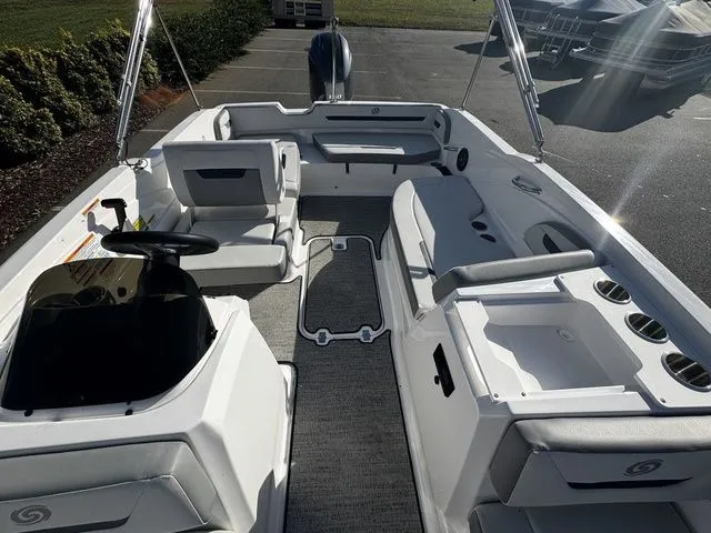 Slide: The Image of 2023 Hurricane SunDeck Sport 205 OB boat interior with seating and steering console. - 10