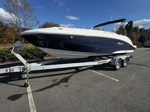 Slide: The Image of 2023 Hurricane SunDeck Sport 205 OB boat on trailer in parking lot. - 2