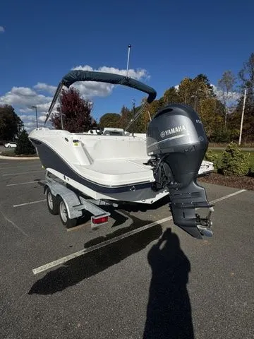 Slide: The Image of 2023 Hurricane SunDeck Sport 205 OB boat with Yamaha outboard motor on a trailer. - 3