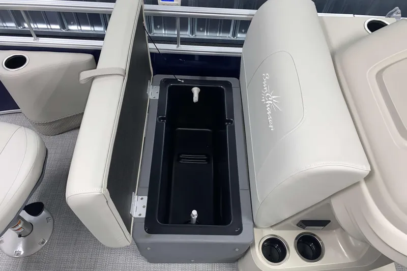 Slide: The Image of SunChaser Vista 18 Fish 2026 boat interior with storage compartment and cup holders. - 12