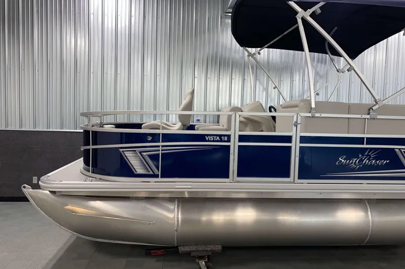 Slide: The Image of 2026 SunChaser Vista 18 Fish pontoon boat in showroom, side view. - 17