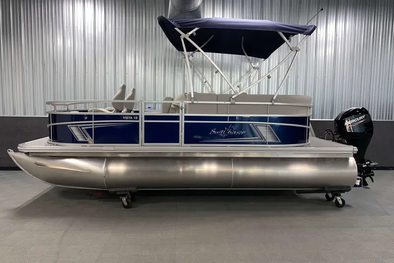 Slide: The Image of 2026 SunChaser Vista 18 Fish pontoon boat with canopy in showroom. - 18
