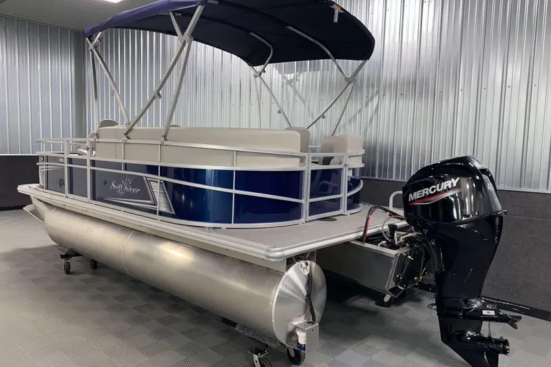 Slide: The Image of 2026 SunChaser Vista 18 Fish pontoon boat with Mercury outboard motor in showroom. - 20