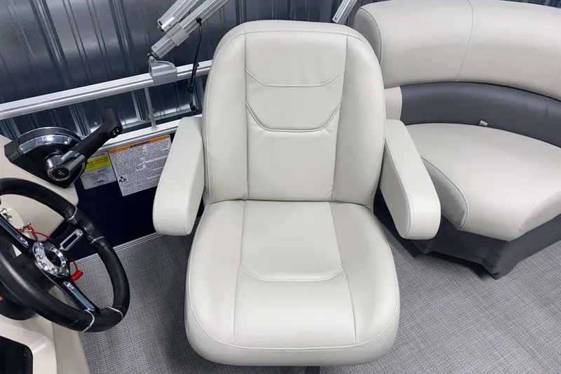 Slide: The Image of 2026 SunChaser Vista 18 Fish boat interior with plush seating and steering wheel. - 7