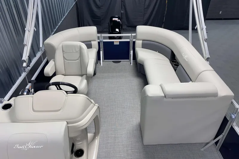 Slide: The Image of 2026 SunChaser Vista 18 Fish pontoon boat interior with plush seating and steering console. - 9