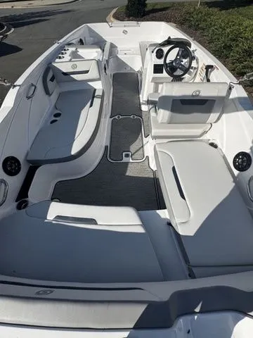 Slide: The Image of 2023 Hurricane SunDeck Sport 205 OB boat interior with seating and steering wheel. - 4