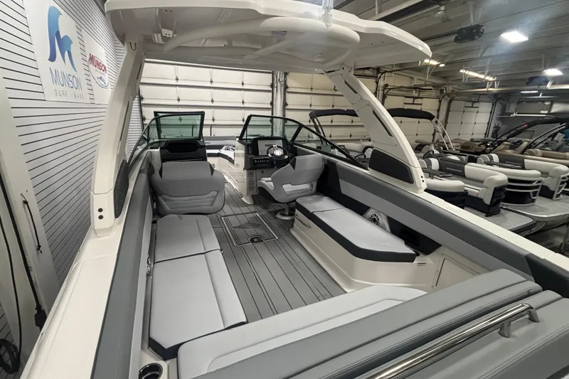Slide: The Image of 2026 Chaparral SSX 30 boat interior with sleek seating and modern design in showroom. - 18