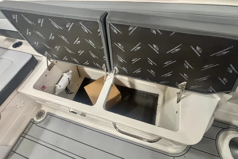 Slide: The Image of 2026 Chaparral SSX 30 boat storage compartment with open lid and visible interior items. - 19
