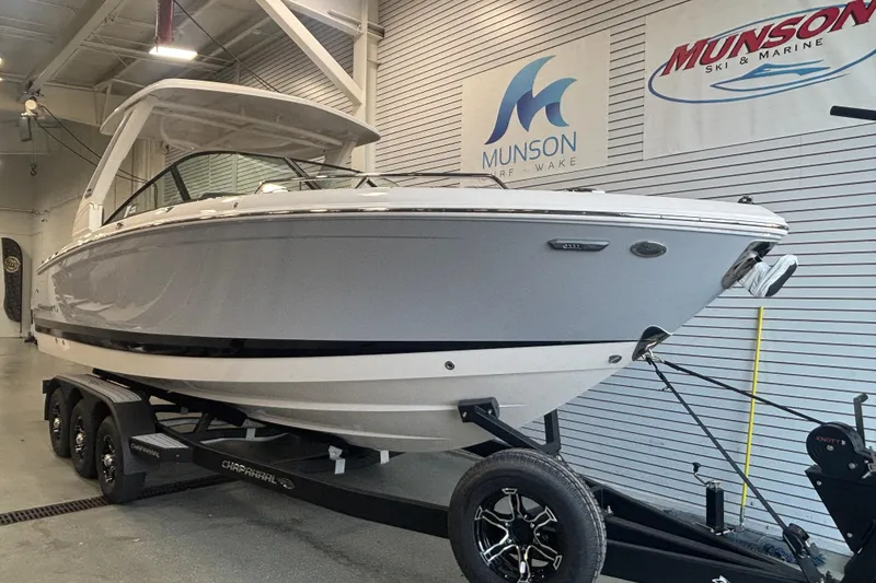 Slide: The Image of 2026 Chaparral SSX 30 boat on trailer in showroom, Munson Ski & Marine signage. - 6