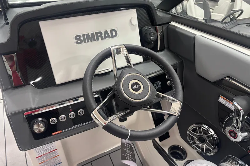 Slide: The Image of 2026 Chaparral SSX 30 boat dashboard with Simrad display and steering wheel. - 9