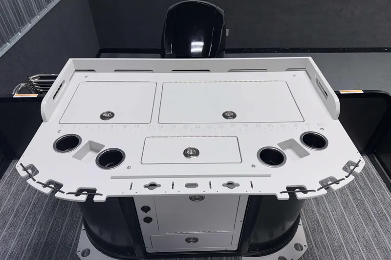 Slide: The Image of 2026 Premier 230 Sunsation Angler Tritoon fishing station with cup holders and storage compartments. - 12