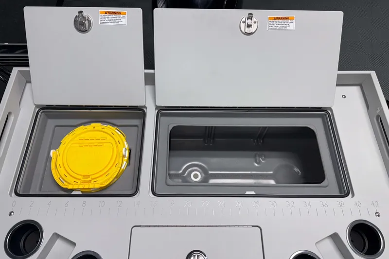 Slide: The Image of 2026 Premier 230 Sunsation Angler Tritoon fishing station with storage compartments and measuring guide. - 13